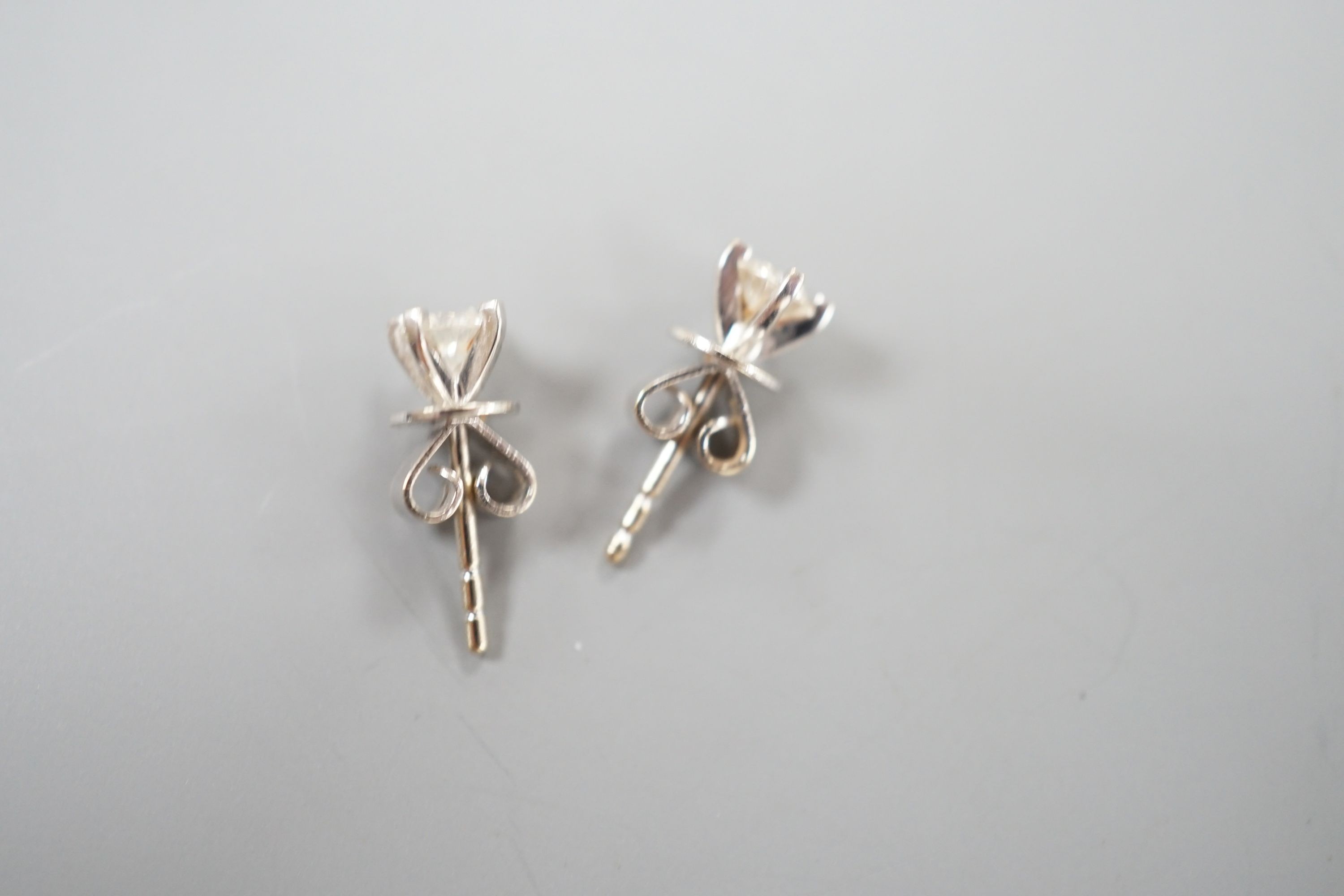 A pair of 750 white metal and solitaire diamond set ear studs, the stones measuring 3.5mm in diameter, gross weight 1.1 grams.